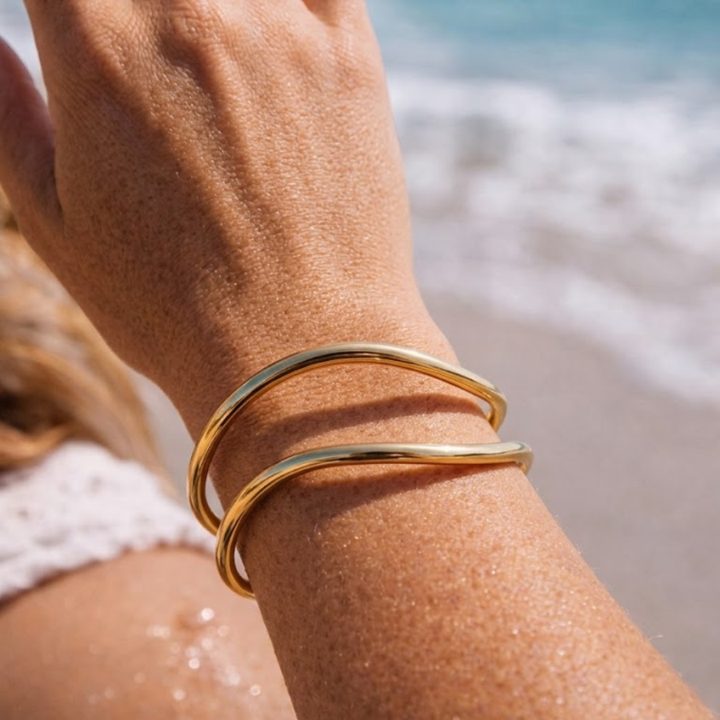Woman wearing the Renaissance Romance cuff by the sea